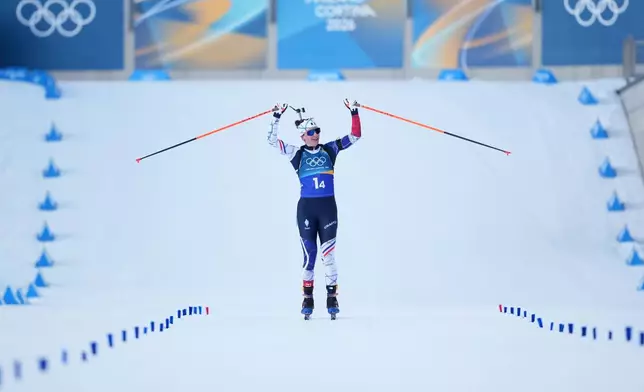 Julia Simon, of France, reacts as her team wins gold in the 4X6-kilometer mixed relay biathlon race at the 2026 Winter Olympics in Anterselva, Italy, Sunday, Feb. 8, 2026. (AP Photo/Andrew Medichini)