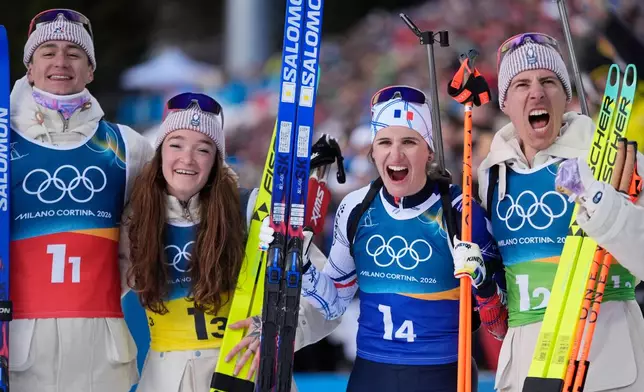 France's Eric Perrot, from left, Lou Jeanmonnot, Julia Simon and Quentin Fillon Maillet celebrate winning gold in the 4X6-kilometer mixed relay biathlon race at the 2026 Winter Olympics in Anterselva, Italy, Sunday, Feb. 8, 2026. (AP Photo/Andrew Medichini)