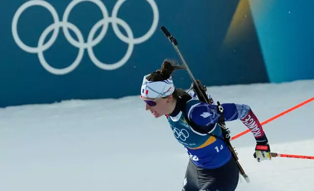 Julia Simon, of France, competes in the 4X6-kilometer mixed relay biathlon race at the 2026 Winter Olympics in Anterselva, Italy, Sunday, Feb. 8, 2026. (AP Photo/Mosa'ab Elshamy)