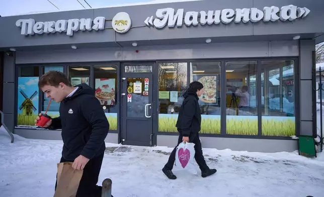 People exit the Mashenka bakery outside Moscow, Russia, Wednesday, Feb. 18, 2026. (AP Photo/Alexander Zemlianichenko)