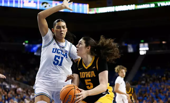 Iowa center Ava Heiden (5) drives against UCLA center Lauren Betts (51) during the first half of an NCAA college basketball game, Sunday, Feb. 1, 2026, in Los Angeles. (AP Photo/Jessie Alcheh)