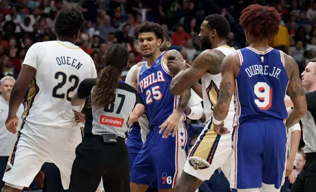New Orleans Pelicans center DeAndre Jordan, center right, holds back Philadelphia 76ers forward Dominick Barlow (25) near to Pelicans center Derik Queen (22) and 76ers guard Kelly Oubre Jr. (9) after Queen was pushed from behind by 76ers center Andre Drummond (not shown) during the first half of an NBA basketball game in New Orleans, Saturday, Feb. 21, 2026. (AP Photo/Matthew Hinton)