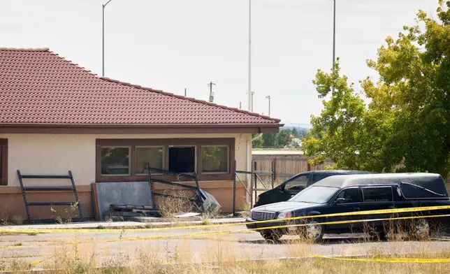 FILE - A hearse and van sit outside the Return to Nature Funeral Home, in Penrose, Colo., Oct. 6, 2023. (AP Photo/David Zalubowski, File)