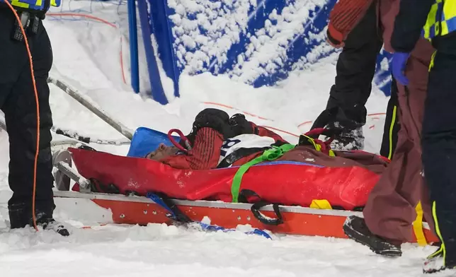 Medical personnel stretcher Canada's Mark McMorris off after crashing during a snowboard big air training session at the 2026 Winter Olympics, in Livigno, Italy, Wednesday, Feb. 4, 2026. (AP Photo/Lindsey Wasson)