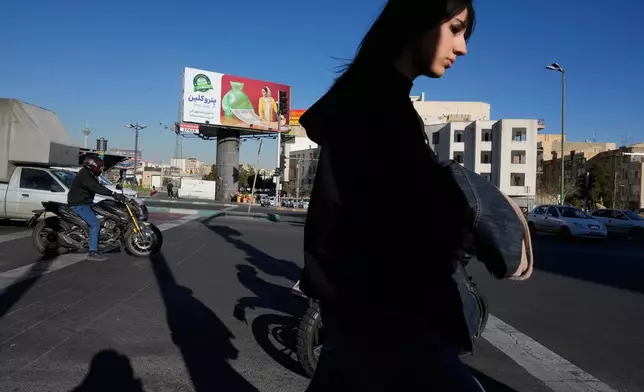 A woman crosses a square in Tehran, Iran, Thursday, Feb. 26, 2026. (AP Photo/Vahid Salemi)