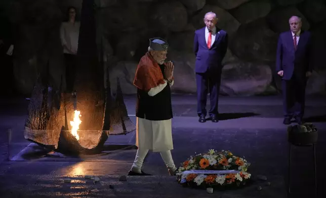 India's Prime Minister Narendra Modi lays a wreath and a rock at the Hall of Remembrance during his visit to the Yad Vashem Holocaust Memorial Museum in Jerusalem, Thursday, Feb. 26, 2026. (AP Photo/Leo Correa)