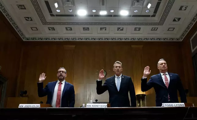From left, Joseph Edlow, director of U.S. Citizenship and Immigration Services, Rodney Scott, commissioner of the U.S. Customs and Border Protection and Todd Lyons, senior official performing the duties of the director at U.S. Immigration and Customs Enforcement, are sworn in before a Senate Homeland Committee hearing on Capitol Hill in Washington, Thursday, Feb. 12, 2026, in Washington. (Chip Somodevilla/Pool via AP)