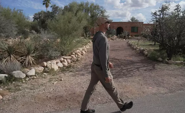 A law enforcement agent takes part in the search for clues around Nancy Guthrie's home in Tucson, Ariz., Wednesday, Feb. 11, 2026. (AP Photo/Ty ONeil)