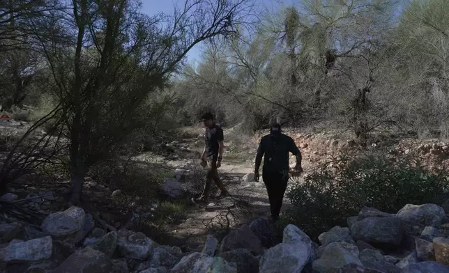 Law enforcement agents check vegetation areas around Nancy Guthrie’s home in Tucson, Ariz., Wednesday, Feb. 11, 2026. (AP Photo/Ty ONeil)