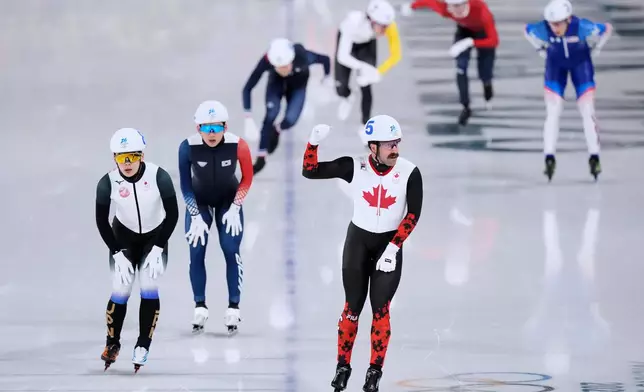 Antoine Gelinas-Beaulieu of Canada flashes a thumbs-up in the men's mass start semifinal speedskating races at the 2026 Winter Olympics, in Milan, Italy, Saturday, Feb. 21, 2026. (AP Photo/Luca Bruno)