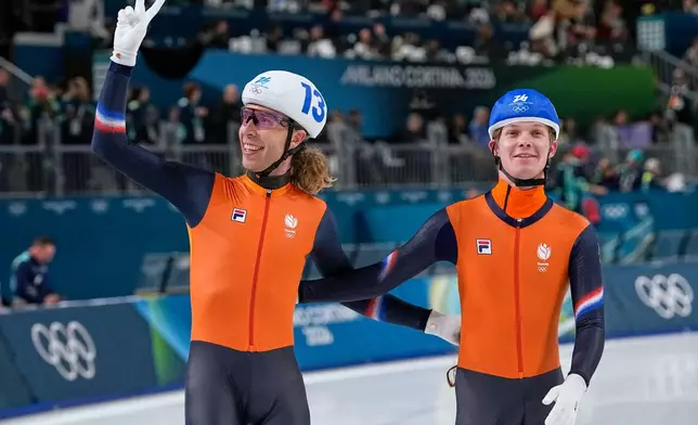 Jorrit Bergsma of the Netherlands, left, celebrates winning the gold medal with his teammate Stijn van de Bunt, right, after the men's mass start final speedskating race at the 2026 Winter Olympics, in Milan, Italy, Saturday, Feb. 21, 2026. (AP Photo/Ben Curtis)