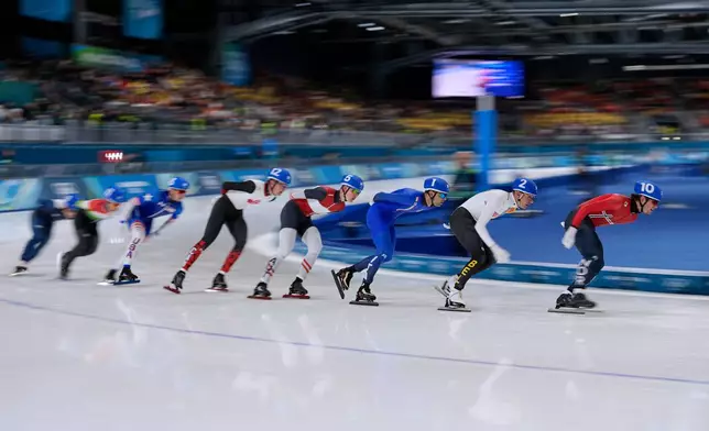 Didrik Eng Strand of Norway leads before Bart Swings of Belgium, Andrea Giovannini of Italy, Gabriel Odor of Austria, Daniel Hall of Canada and others in the men's mass start semifinal speedskating races at the 2026 Winter Olympics, in Milan, Italy, Saturday, Feb. 21, 2026. (AP Photo/Ben Curtis)