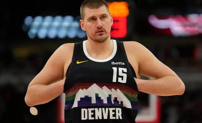 Denver Nuggets center Nikola Jokic (15) sticks his hands in his jersey during the second half of an NBA basketball game against the Chicago Bulls, Saturday, Feb. 7, 2026, in Chicago. (AP Photo/Erin Hooley)