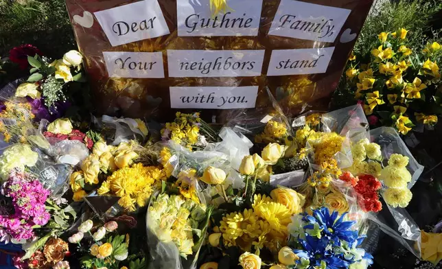 A memorial grows outside the home of Nancy Guthrie, the missing mother of "Today" show host Savannah Guthrie, Sunday, Feb. 22, 2026, in Tucson, Ariz. (AP Photo/Felicia Fonseca)