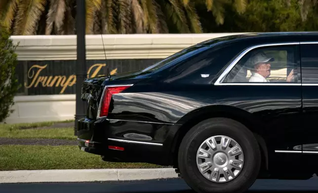 President Donald Trump rides in his limousine as he leaves the Trump International Golf Club, Sunday, Feb. 8, 2026, in West Palm Beach, Fla. (AP Photo/Mark Schiefelbein)