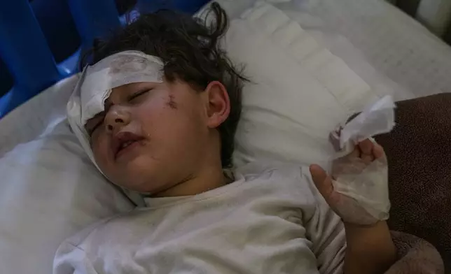 Syrian Menisa Taha, who was wounded in an Israeli airstrike, lies in Rayak Hospital in eastern Lebanon, Saturday, Feb. 21, 2026. (AP Photo/Bilal Hussein)