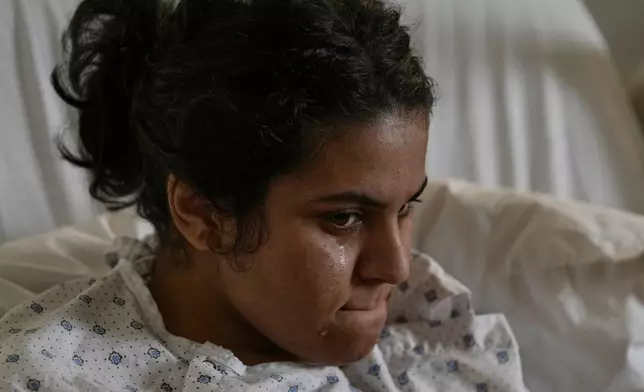 Syrian Razan al-Jassem, who was wounded in an Israeli airstrike, lies in Rayak Hospital in eastern Lebanon, Saturday, Feb. 21, 2026. (AP Photo/Bilal Hussein)