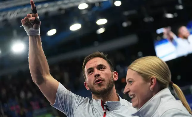 United States' Korey Dropkin, left, and United States' Cory Thiesse react following the semi-finals round of the mixed doubles curling match against Italy, at the 2026 Winter Olympics, in Cortina d'Ampezzo, Italy, Monday, Feb. 9, 2026. (AP Photo/Fatima Shbair)