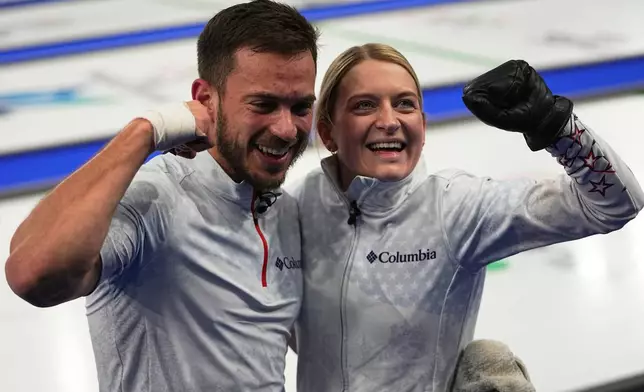 United States' Korey Dropkin, left, and United States' Cory Thiesse react following their semi-finals round of the mixed doubles curling match against Italy, at the 2026 Winter Olympics, in Cortina d'Ampezzo, Italy, Monday, Feb. 9, 2026. (AP Photo/Fatima Shbair)
