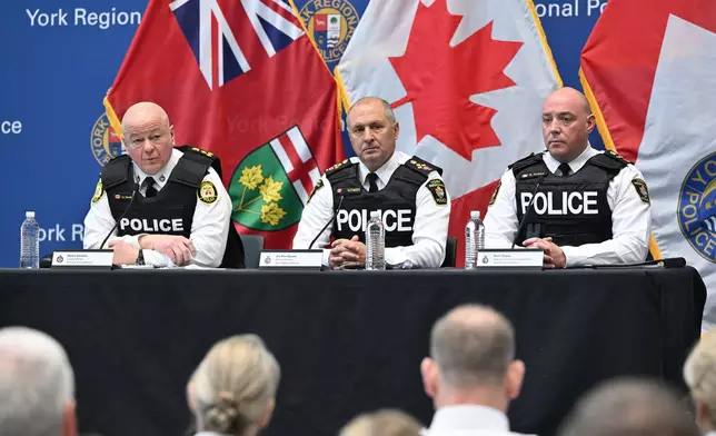Toronto police service chief Myron Demkiw, left, is joined by York regional police chief Jim MacSween, center, and YRP deputy chief Ryan Hogan at a news conference to announce the results of 'Project South,' a lengthy investigation into organized crime and corruption at York Regional police headquarters in Aurora, Ont. on Thursday, Feb. 5, 2026. (Jon Blacker /The Canadian Press via AP)