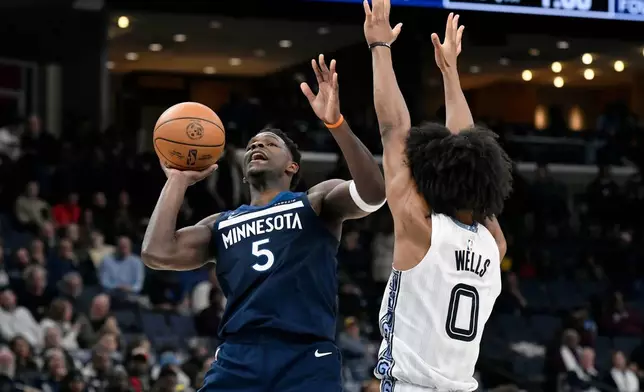 Minnesota Timberwolves guard Anthony Edwards (5) shoots against Memphis Grizzlies forward Jaylen Wells (0) in the first half of an NBA basketball game Monday, Feb. 2, 2026, in Memphis, Tenn. (AP Photo/Brandon Dill)