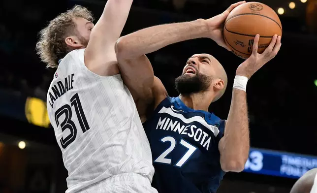 Minnesota Timberwolves center Rudy Gobert (27) looks to shoot against Memphis Grizzlies center Jock Landale (31) in the first half of an NBA basketball game Monday, Feb. 2, 2026, in Memphis, Tenn. (AP Photo/Brandon Dill)