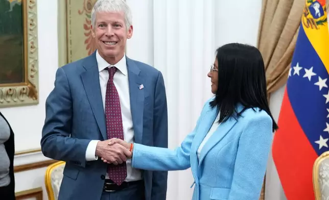 Venezuelan acting President Delcy Rodriguez greets U.S. Energy Secretary Chris Wright at Miraflores presidential palace in Caracas, Venezuela, Wednesday, Feb. 11, 2026. (AP Photo/Ariana Cubillos)