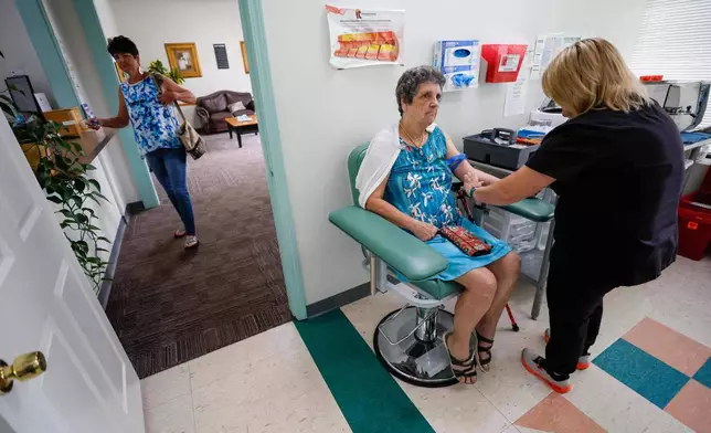 Faye Jackson gets her blood tested at a medical clinic in Calhoun, Ga., on Tuesday, Sept. 30, 2025, as her daughter Marie waits outside for her turn. Their blood tests revealed they have PFAS levels above the safety threshold outlined by national health experts. (Miguel Martinez/Atlanta Journal-Constitution via AP)