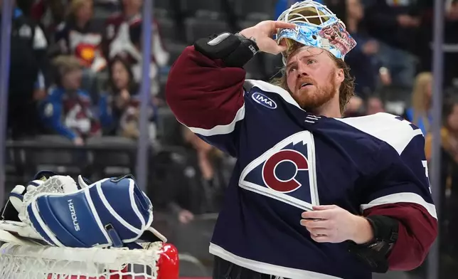 Colorado Avalanche goaltender MacKenzie Blackwood pulls on his mask during a break in the second period of an NHL hockey game against the Minnesota Wild, Thursday, Feb. 26, 2026, in Denver. (AP Photo/David Zalubowski)