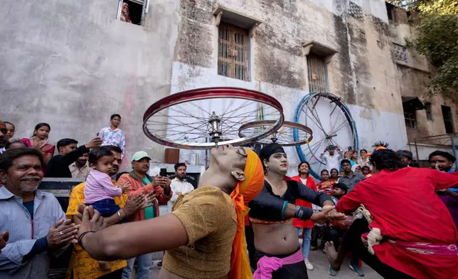 Artists dances during a procession on the occasion of Maha Shivaratri festival, as Hindus across the world celebrate Maha Shivratri, or the night of Shiva, observed on a moonless night annually and believed to be the day when Shiva got married, in Prayagraj, India, Sunday, Feb. 15, 2026. (AP Photo/Rajesh Kumar Singh)