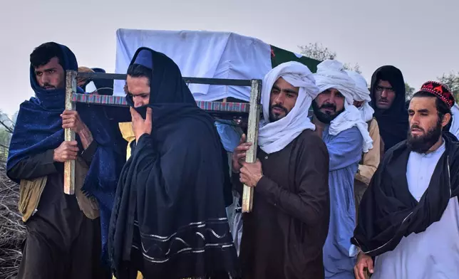 People carry the coffin of an army soldier, killed in the cross-border clashes of Pakistan and Afghan forces, for his funeral prayer at a village in Lakki Marwat, a district of Pakistan's Khyber Pakhtunkhwa province, Saturday, Feb. 28, 2026. (AP Photo/G.A. Marwat)