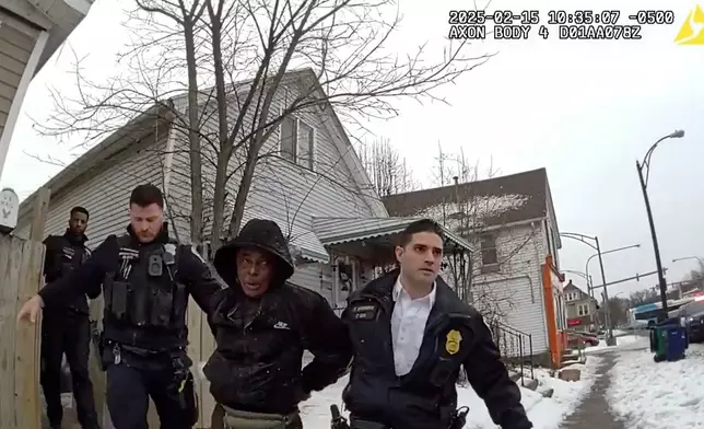 This image from body camera video provided by the Buffalo Police Department shows Nurul Amin Shah Alam, center, led by Buffalo Police officers after being arrested on charges of assault, burglary and criminal mischief in Buffalo, N.Y., on Feb. 15, 2025. (Buffalo Police Department via AP)