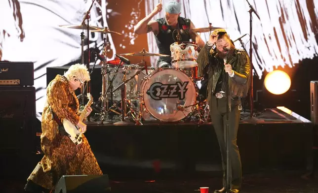 Andrew Watt, from left, Chad Smith, and Post Malone perrform "War Pigs" during the in memoriam tribute for the 68th annual Grammy Awards on Sunday, Feb. 1, 2026, in Los Angeles. (AP Photo/Chris Pizzello)