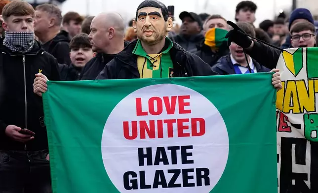 Manchester United fans protest against the club's owners, the Glazer family, prior to the English Premier League soccer match between Manchester United and Fulham in Manchester, England, Sunday, Feb. 1, 2026. (AP Photo/Dave Thompson)