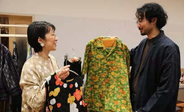 Designer Tomoko Ohkata, left, and her assistant Koki Unami hold Ohkata's designs made from old kimono, in Tokyo, on Jan. 15, 2026. (AP Photo/Yuri Kageyama)