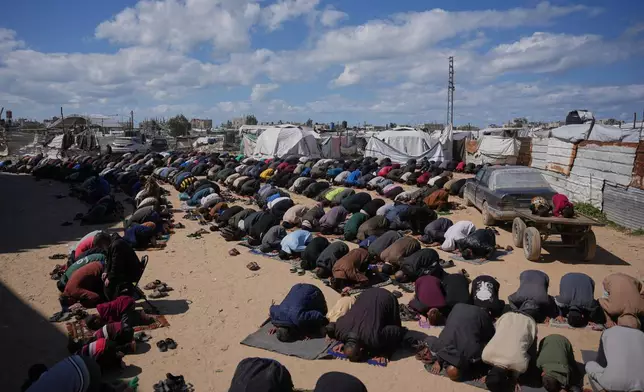 Muslim worshippers perform Friday prayers during the holy month of Ramadan outside the destroyed Al-Albani Mosque, in Khan Younis, southern Gaza Strip, Friday, Feb. 27, 2026. (AP Photo/Abdel Kareem Hana)
