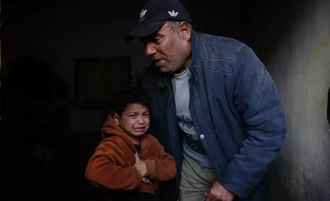 Yazid Al-Zayan, 9, mourns during the funeral of his father Khaled Al-Zayan, a Palestinian policeman, who was killed in an Israeli military strike, in Khan Younis, southern Gaza Strip, Friday, Feb. 27, 2026. (AP Photo/Abdel Kareem Hana)