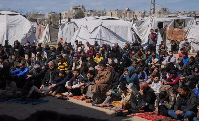 Muslim worshippers take part in the Friday prayers during the holy month of Ramadan outside the destroyed Al-Albani Mosque, in Khan Younis, southern Gaza Strip, Friday, Feb. 27, 2026. (AP Photo/Abdel Kareem Hana)