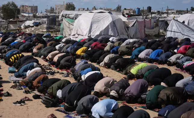 Muslim worshippers perform Friday prayers during the holy month of Ramadan outside the destroyed Al-Albani Mosque, in Khan Younis, southern Gaza Strip, Friday, Feb. 27, 2026. (AP Photo/Abdel Kareem Hana)
