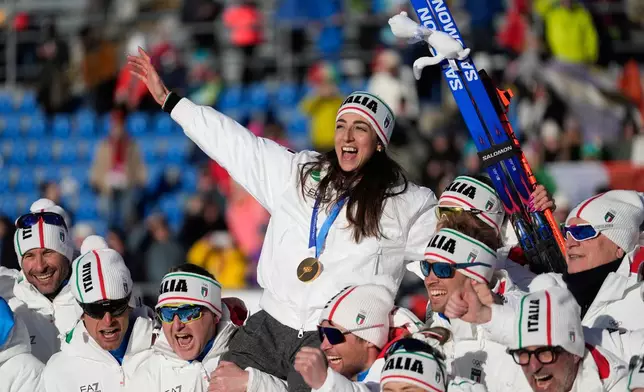 CORRECTS BYLINE: Gold medalist Lisa Vittozzi, of Italy, poses with teammates after the women's 10-kilometer pursuit biathlon race at the 2026 Winter Olympics in Anterselva, Italy, Sunday, Feb. 15, 2026. (AP Photo/Mosa'ab Elshamy)