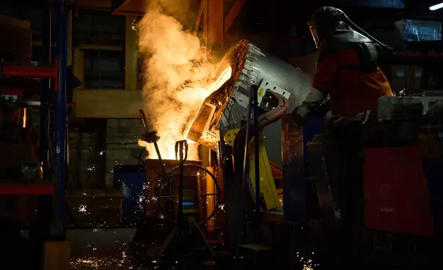 A furnace worker pour molten metal as part of the process to create BAFTA masks at FSE Foundry in Braintree, England on Tuesday, Feb. 10, 2026. (Scott A Garfitt/Invision/AP)