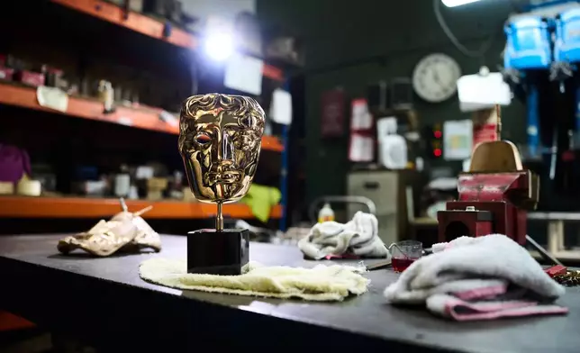 A completed British Academy Film Awards mask sits on a workbench at the FSE Foundry in Braintree, England on Tuesday, Feb. 10, 2026. (Scott A Garfitt/Invision/AP)