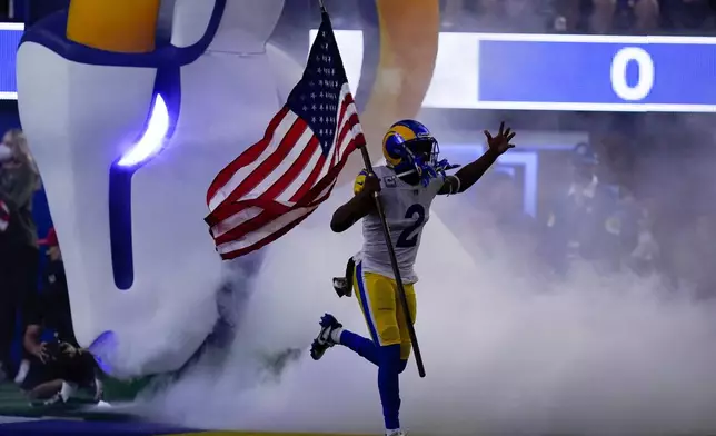 FILE - Los Angeles Rams wide receiver Robert Woods carries a flag as part of the league's Salute to Service before an NFL football game against the Tennessee Titans Nov. 7, 2021, in Inglewood, Calif. (AP Photo/Ashley Landis, File)