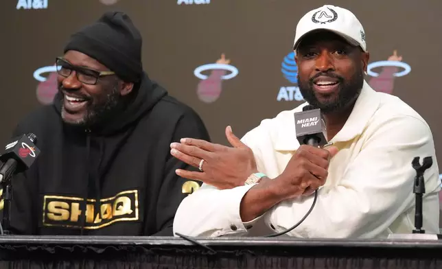 Former Miami Heat players Dwyane Wade, right and Shaquille O'Neal talk about their experience winning the NBA finals 20 years ago during a news conference Tuesday, Feb. 3, 2026, in Miami. (AP Photo/Marta Lavandier)