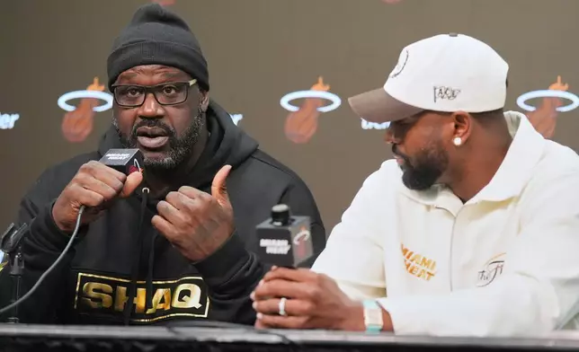 Former Miami Heat players Dwyane Wade, right and Shaquille O'Neal talk about their experience winning the NBA finals 20 years ago during a news conference Tuesday, Feb. 3, 2026, in Miami. (AP Photo/Marta Lavandier)
