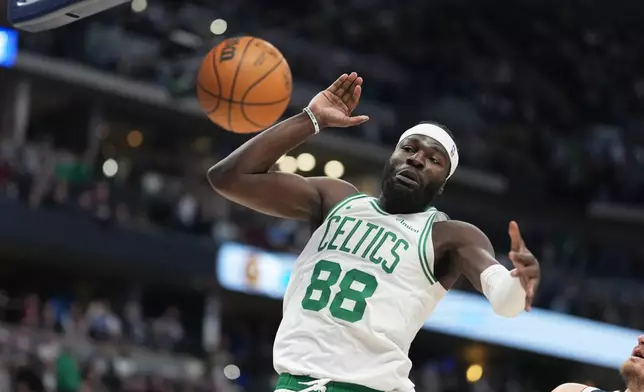 Boston Celtics center Neemias Queta reacts after dunking the ball for a basket in the first half of an NBA basketball game against the Denver Nuggets Wednesday, Feb. 25, 2026, in Denver. (AP Photo/David Zalubowski)
