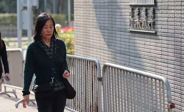 Chan Po-ying, wife of Leung Kwok-hung, one of the defendants in the national security case and the former chairperson of the now-disbanded League of Social Democrats arrives at the West Kowloon Law Courts Building ahead of the national security appeal cases, in Hong Kong, Monday, Feb. 23, 2026. (AP Photo/May James)