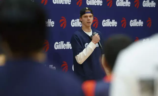 Toronto Raptors player and Gillette ambassador Gradey Dick speaks with Lay-Up youth coaches during an on-court learning session hosted by Gillette in Toronto.