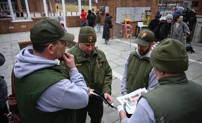 National Parks Service workers gather as panels that were part of an exhibit on slavery at the President's House Site in Philadelphia are put back Thursday, Feb. 19, 2026. (AP Photo/Joe Lamberti)