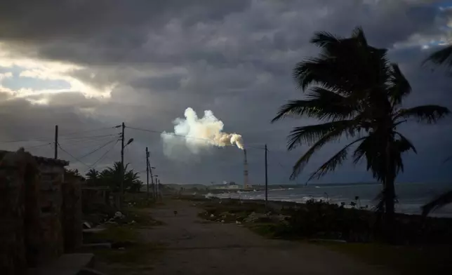Smoke rises from the chimney of the Antonio Guiteras thermoelectric power plant in Santa Cruz del Norte, Cuba, at sunset Tuesday, Feb. 3, 2026. (AP Photo/Ramon Espinosa)